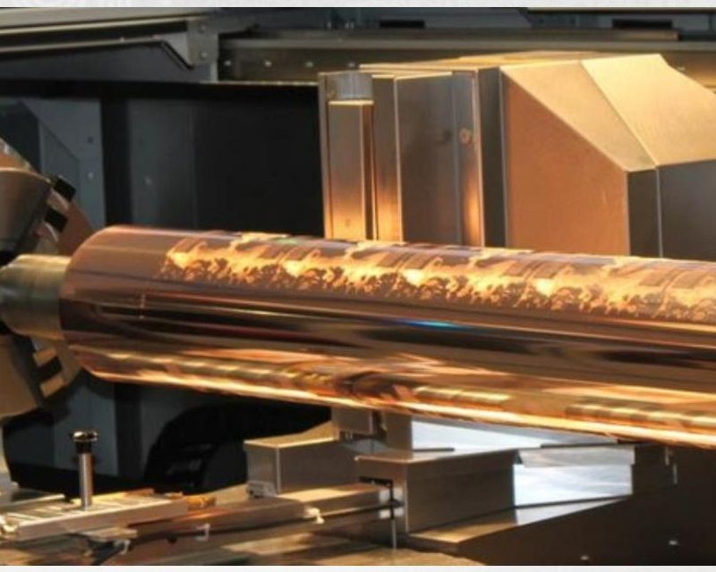 A copper rotogravure cylinder mounted in an engraving machine